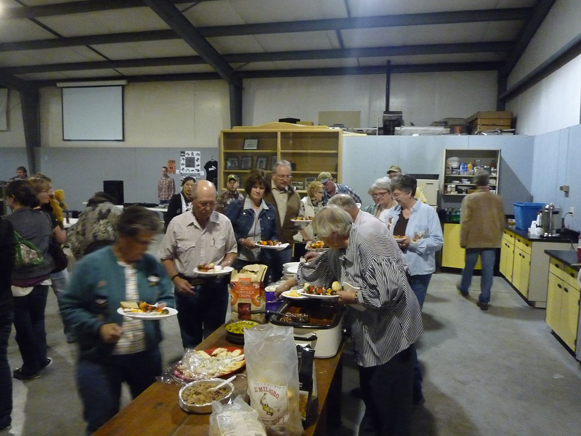People lined up to serve themselves food at The Big Feed potluck