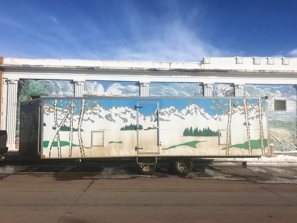 Detail of painted trailer in-front of Fred Haberlein mural